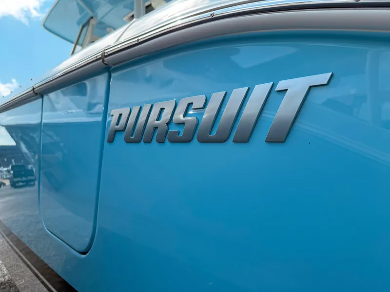 Slide: The Image of 2025 Pursuit S 288 Sport boat in vibrant blue, showcasing sleek design. - 3