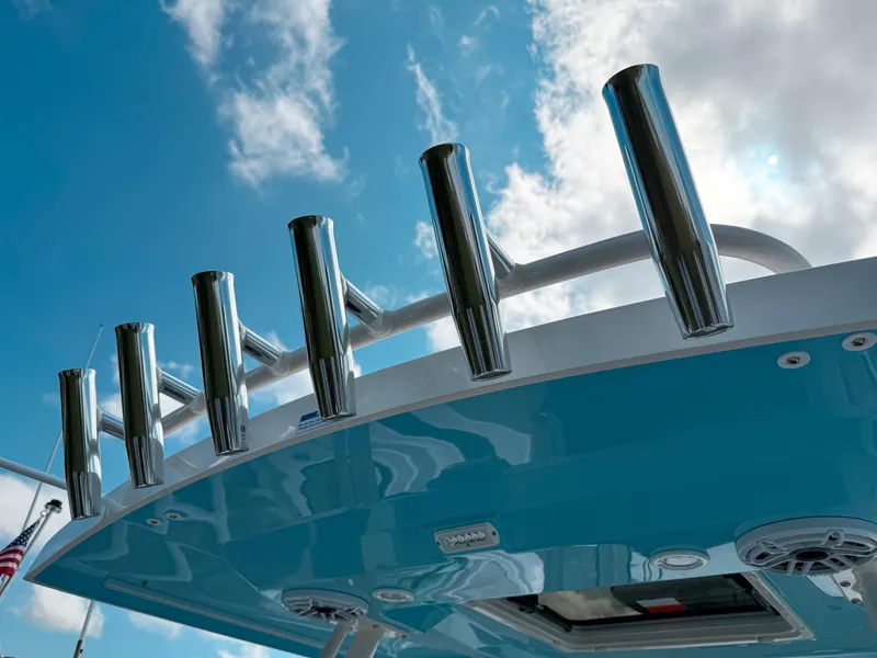 Slide: The Image of 2025 Pursuit S 288 Sport boat with rod holders against a blue sky. - 5