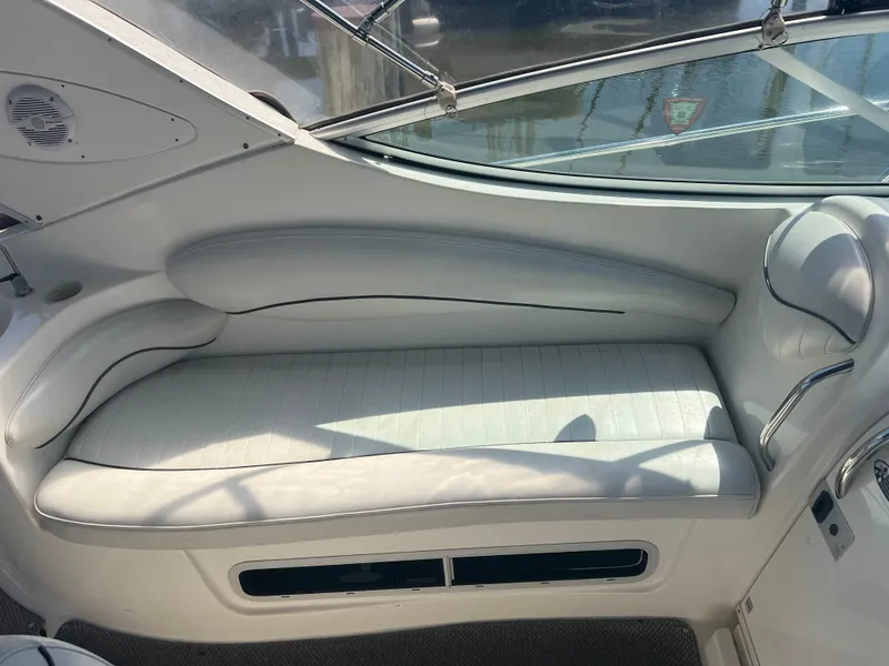Slide: The Image of Interior of a 2004 Maxum 2700 SE yacht with white seating area. - 10