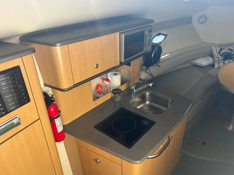 Slide: The Image of Interior of 2004 Maxum 2700 SE with kitchenette and seating area. - 12