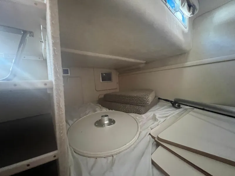 Slide: The Image of Interior of 2004 Maxum 2700 SE yacht, featuring sleeping area and window. - 15