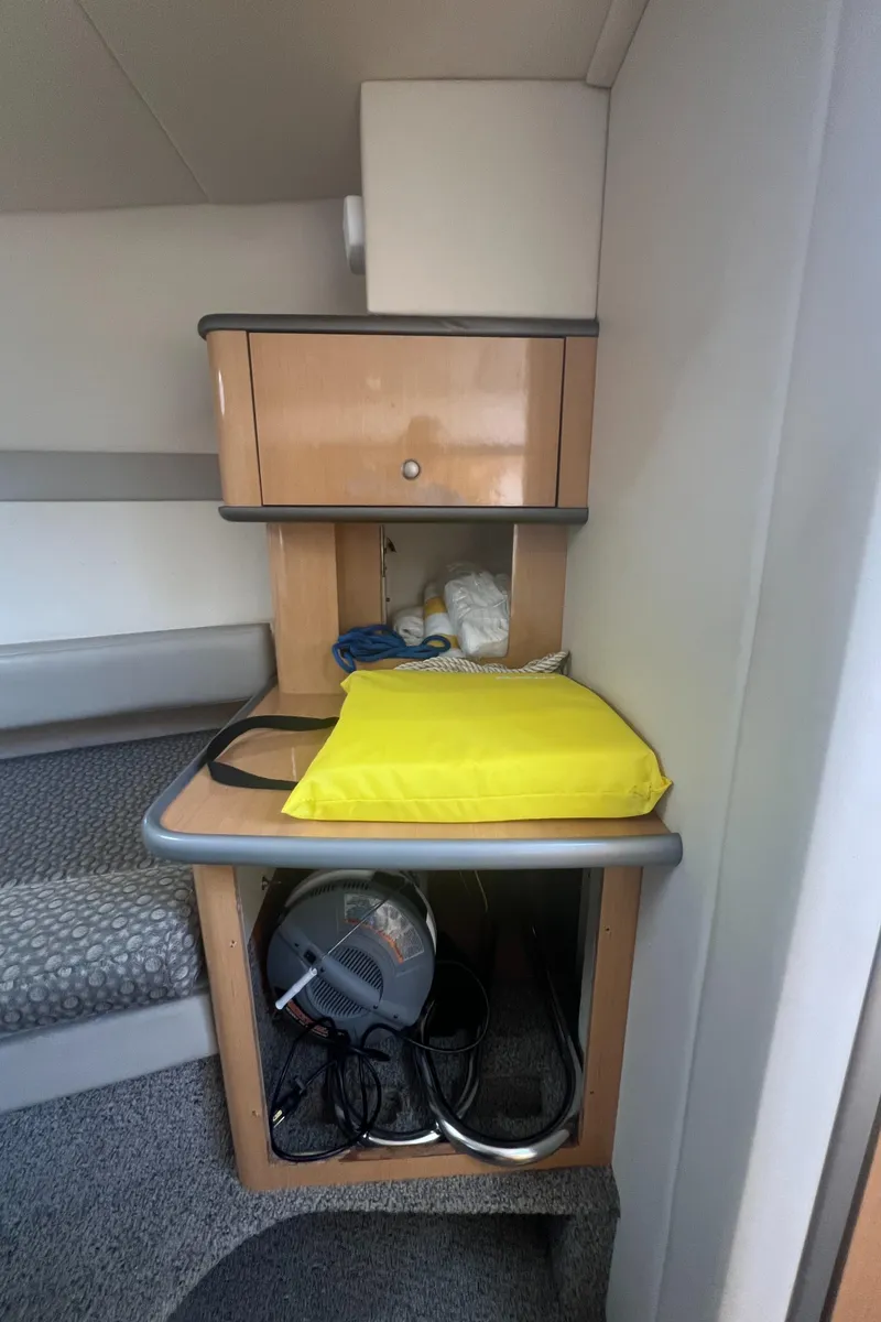 Slide: The Image of Interior of 2004 Maxum 2700 SE with storage and seating area. - 17