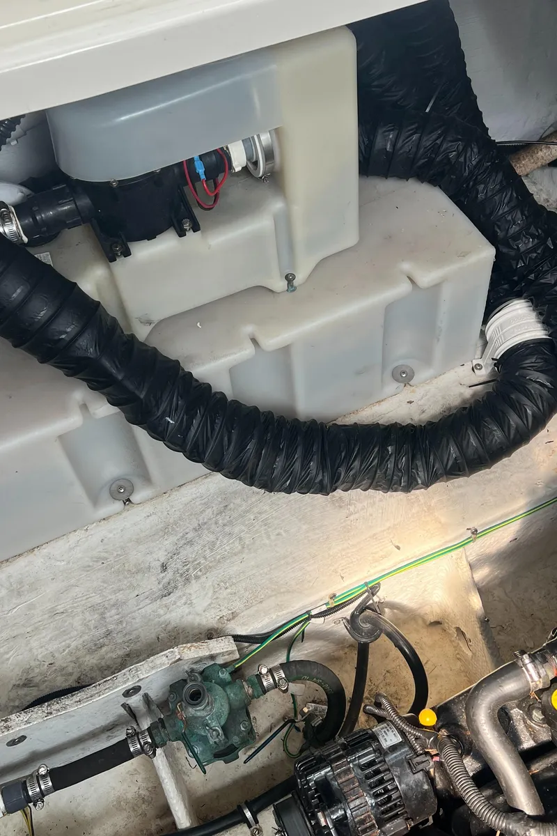 Slide: The Image of Engine compartment of 2004 Maxum 2700 SE boat with hoses and components. - 23