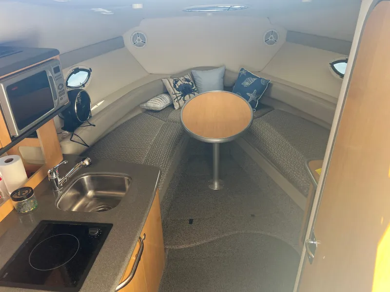 Slide: The Image of Interior of a 2004 Maxum 2700 SE yacht with kitchenette and seating area. - 3