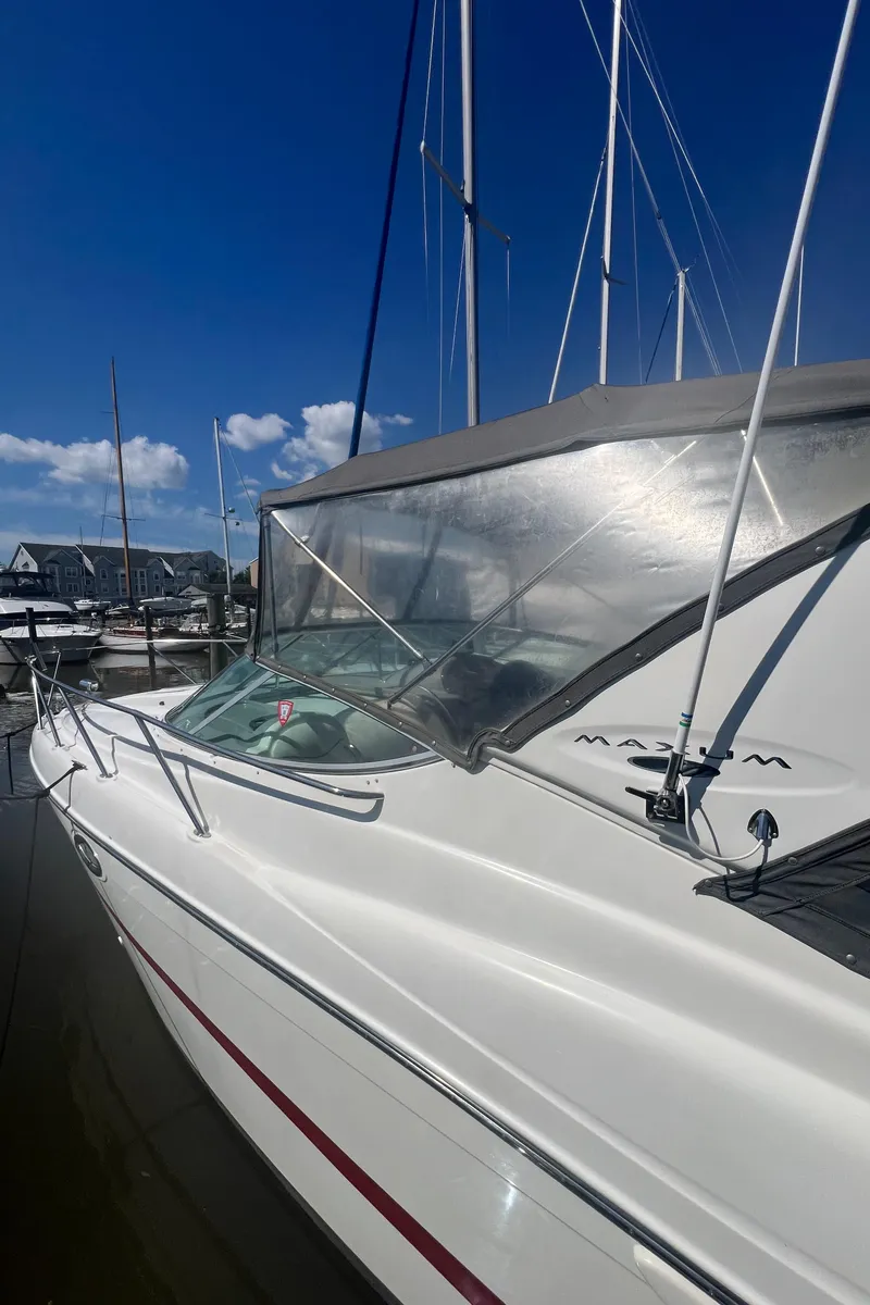 Slide: The Image of 2004 Maxum 2700 SE boat docked under clear sky. - 4