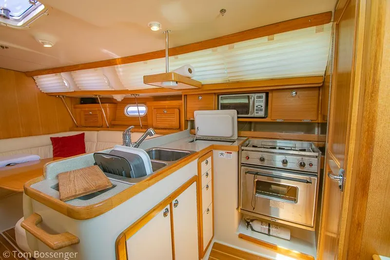 Slide: The Image of Interior of 2006 Catalina 34' MKII yacht featuring kitchen and dining area. - 10