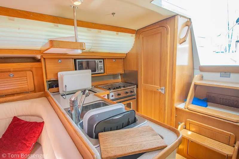 Slide: The Image of Interior of 2006 Catalina 34' MKII sailboat with kitchen and seating area. - 11