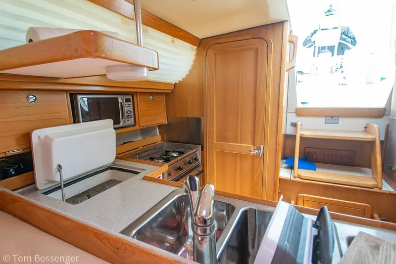 Slide: The Image of Interior of 2006 Catalina 34' MKII yacht featuring a compact kitchen area. - 12