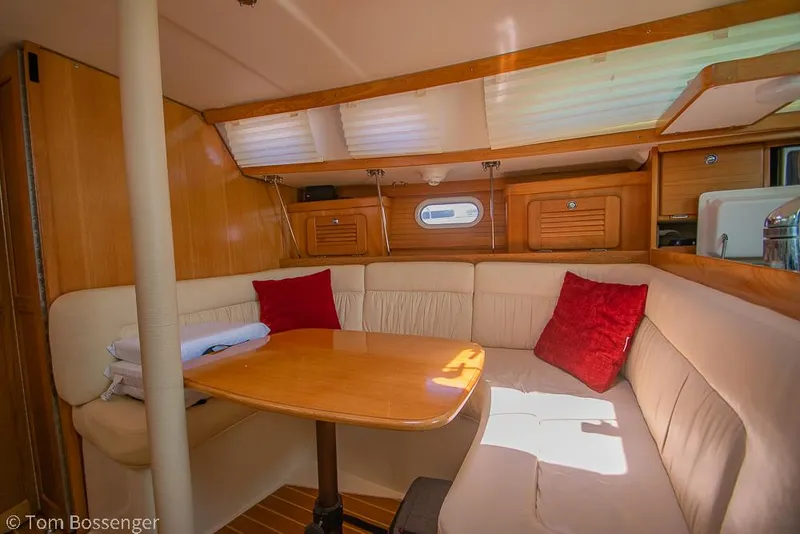 Slide: The Image of Interior of 2006 Catalina 34' MKII sailboat with cozy seating and wooden table. - 14