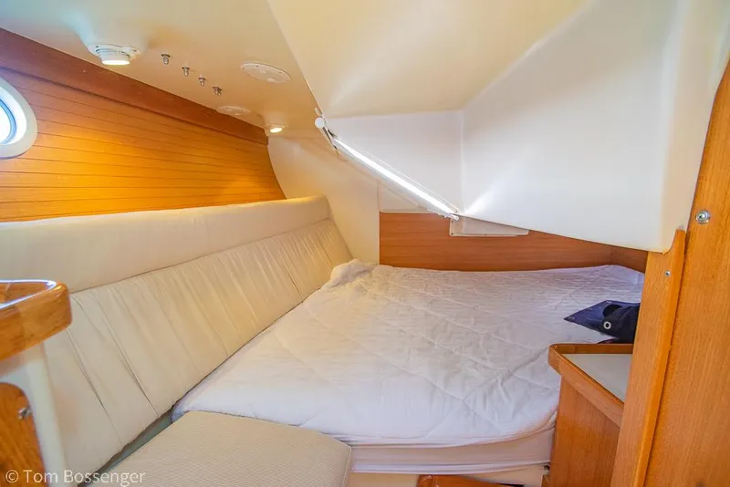 Slide: The Image of Cozy cabin interior of 2006 Catalina 34' MKII sailboat with wooden accents and comfortable bedding. - 19