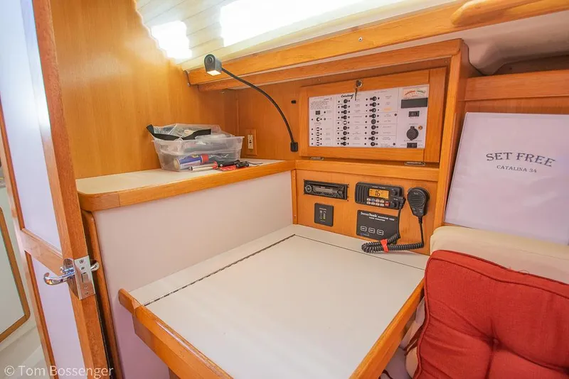 Slide: The Image of Navigation station inside 2006 Catalina 34' MKII sailboat with control panel and radio equipment. - 22