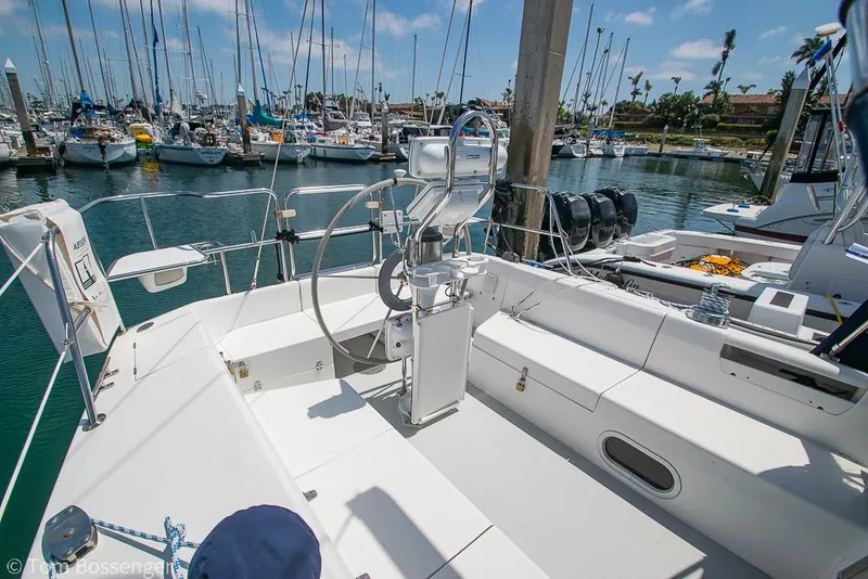 Slide: The Image of 2006 Catalina 34' MKII sailboat cockpit with marina view, featuring steering wheel and seating. - 24