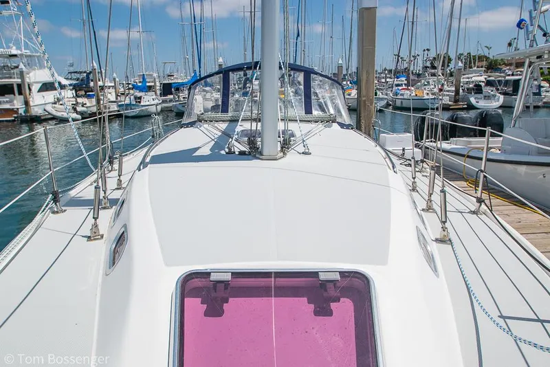 Slide: The Image of 2006 Catalina 34' MKII sailboat docked in a marina, showcasing deck and mast. - 36