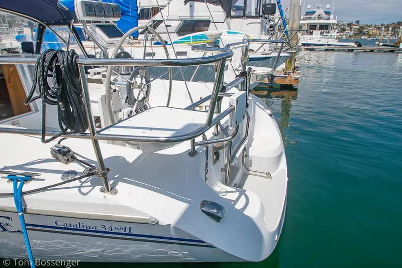 Slide: The Image of Catalina 34' MKII 2006 sailboat docked in marina, featuring sleek design and stainless steel railings. - 5