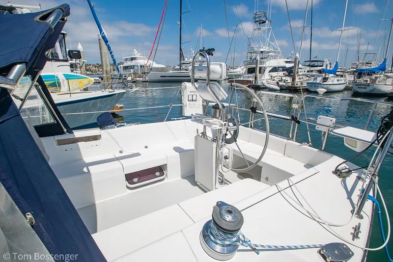 Slide: The Image of 2006 Catalina 34' MKII sailboat cockpit in marina, featuring steering wheel and winch. - 6