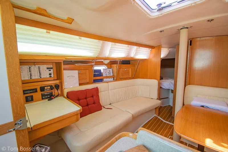 Slide: The Image of Interior of 2006 Catalina 34' MKII sailboat with cozy seating and wooden finishes. - 8