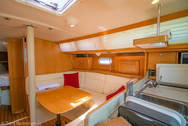 Slide: The Image of Interior of 2006 Catalina 34' MKII sailboat with cozy seating and wooden finishes. - 9