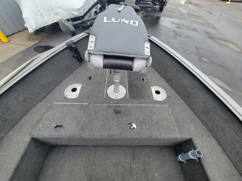 Slide: The Image of 2013 Lund 1650 Rebel XL Tiller boat interior with seating and storage compartments. - 14