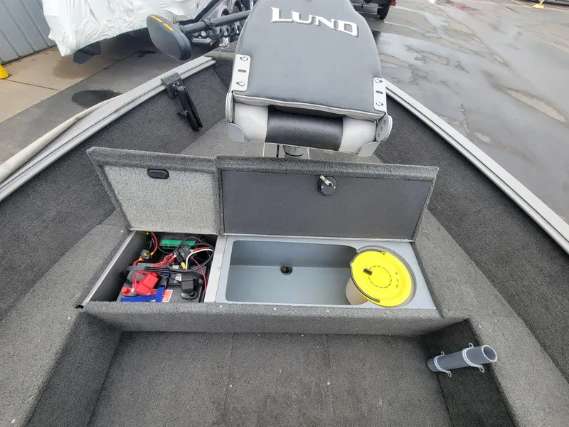 Slide: The Image of 2013 Lund 1650 Rebel XL Tiller boat interior with open storage compartments and equipment. - 15