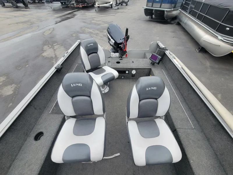 Slide: The Image of 2013 Lund 1650 Rebel XL Tiller boat interior with gray and white seating. - 23
