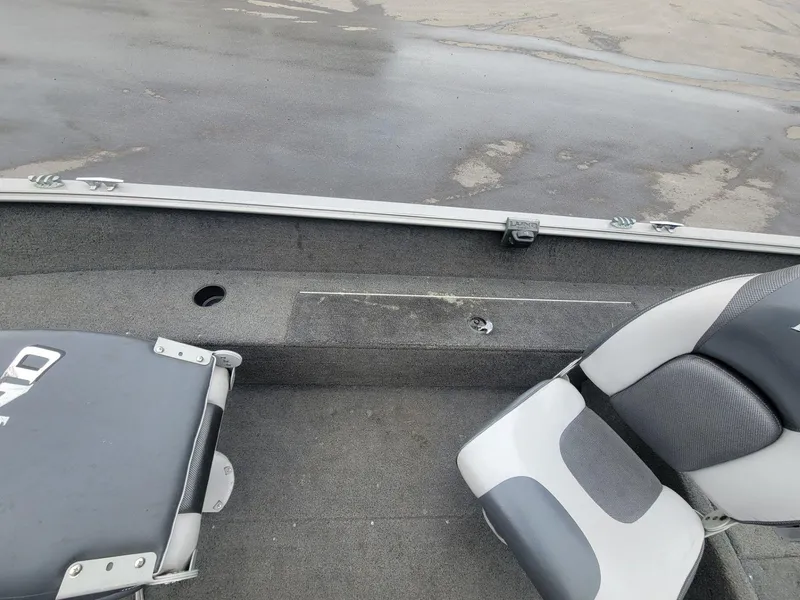 Slide: The Image of 2013 Lund 1650 Rebel XL Tiller boat interior with seating and storage compartments. - 26