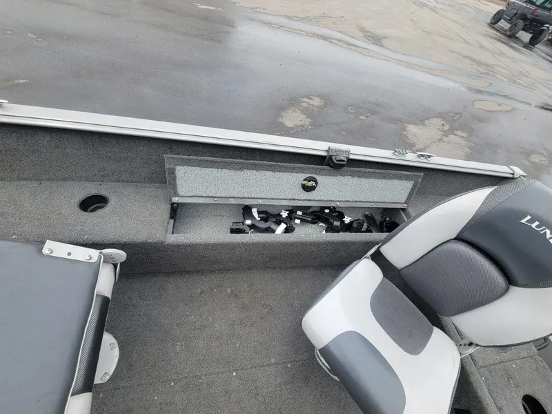 Slide: The Image of 2013 Lund 1650 Rebel XL Tiller boat interior with storage compartment and seating. - 27