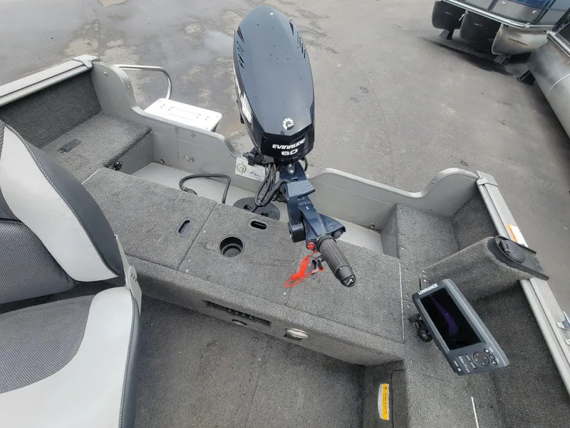 Slide: The Image of 2013 Lund 1650 Rebel XL Tiller boat interior with Evinrude motor and Lowrance fish finder. - 28