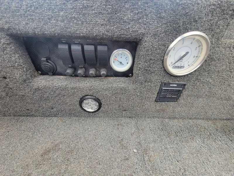 Slide: The Image of Control panel of 2013 Lund 1650 Rebel XL Tiller boat with gauges and switches. - 29