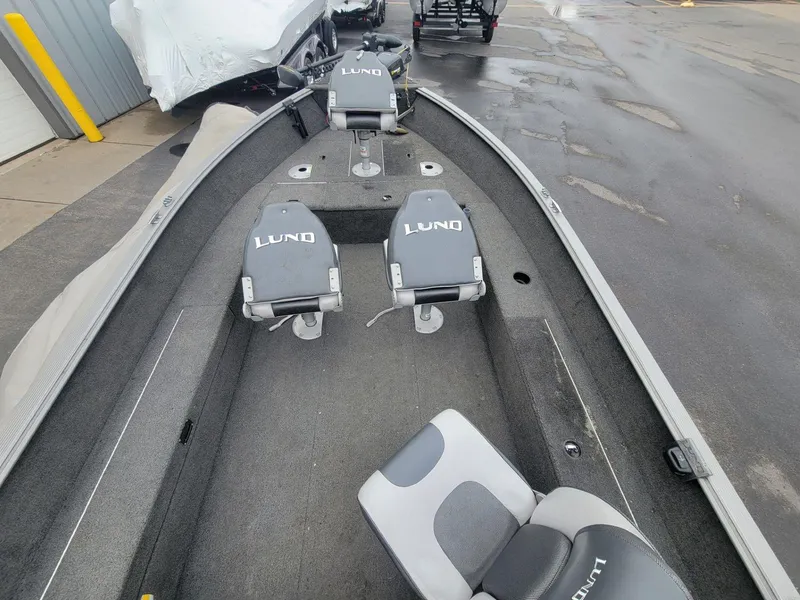 Slide: The Image of 2013 Lund 1650 Rebel XL Tiller boat interior with seating and storage compartments. - 30