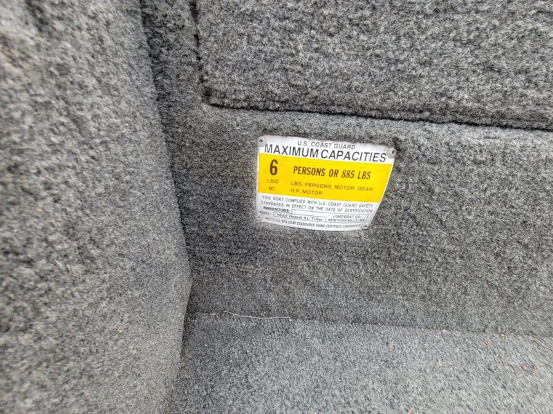 Slide: The Image of 2013 Lund 1650 Rebel XL Tiller capacity label, 6 persons or 885 lbs limit. - 32
