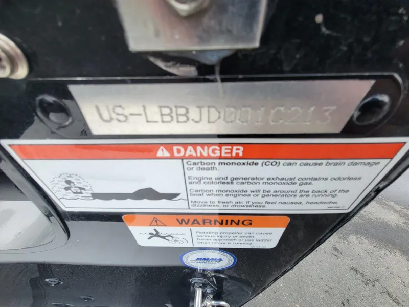 Slide: The Image of 2013 Lund 1650 Rebel XL Tiller warning labels on carbon monoxide and propeller safety. - 33