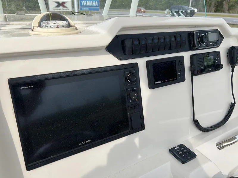Slide: The Image of Dashboard of 2017 Sailfish 270 CC boat with Garmin navigation and communication equipment. - 11