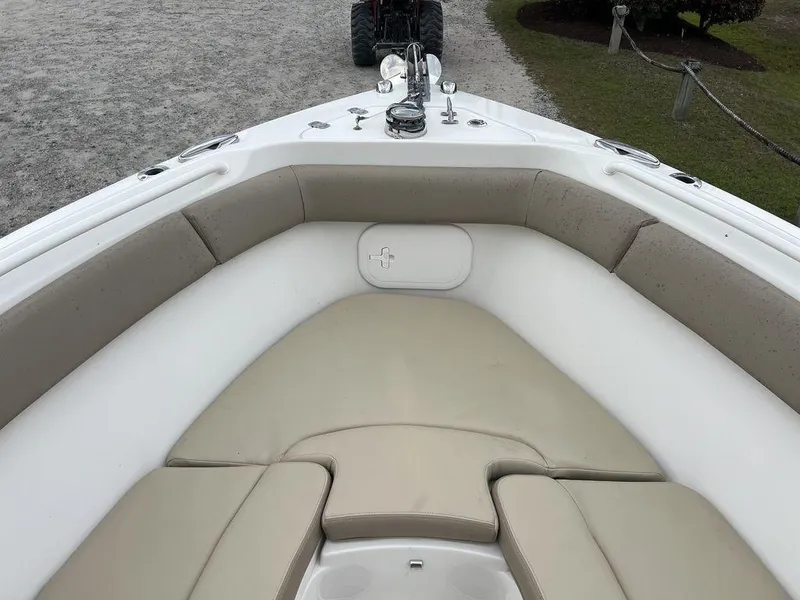 Slide: The Image of Bow seating area of a 2017 Sailfish 270 CC boat with beige cushions. - 12