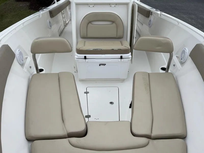 Slide: The Image of 2017 Sailfish 270 CC boat interior with beige cushioned seating. - 13