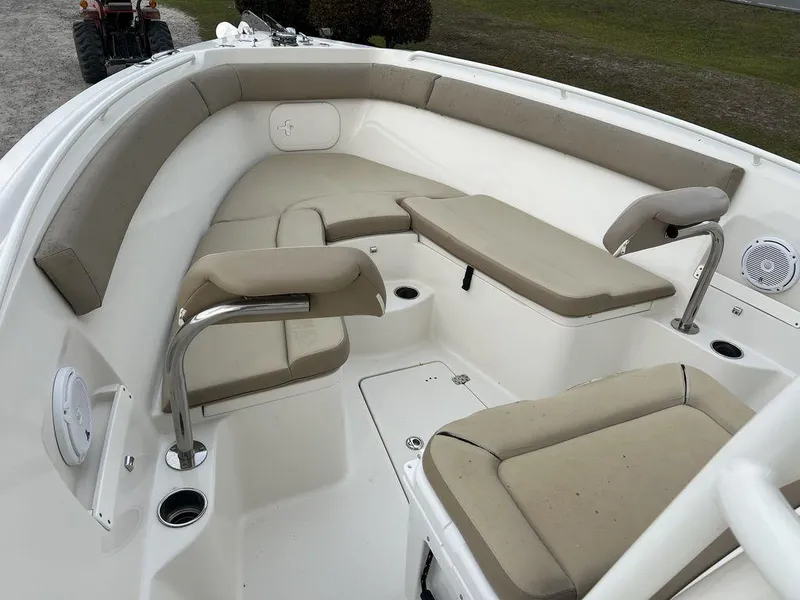 Slide: The Image of 2017 Sailfish 270 CC boat interior with beige seating and stainless steel fixtures. - 16