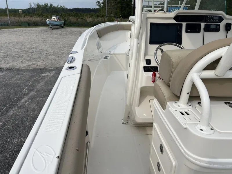 Slide: The Image of 2017 Sailfish 270 CC boat interior with beige seating and control panel. - 20