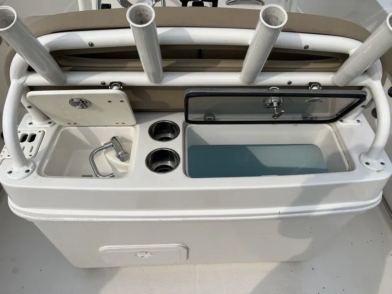 Slide: The Image of 2017 Sailfish 270 CC boat console with rod holders and storage compartments. - 21