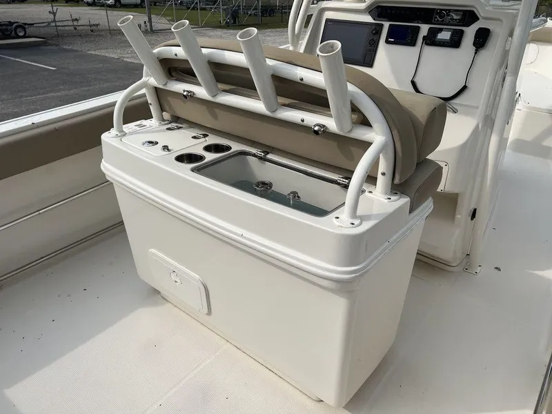 Slide: The Image of 2017 Sailfish 270 CC boat with rod holders and storage compartment. - 22