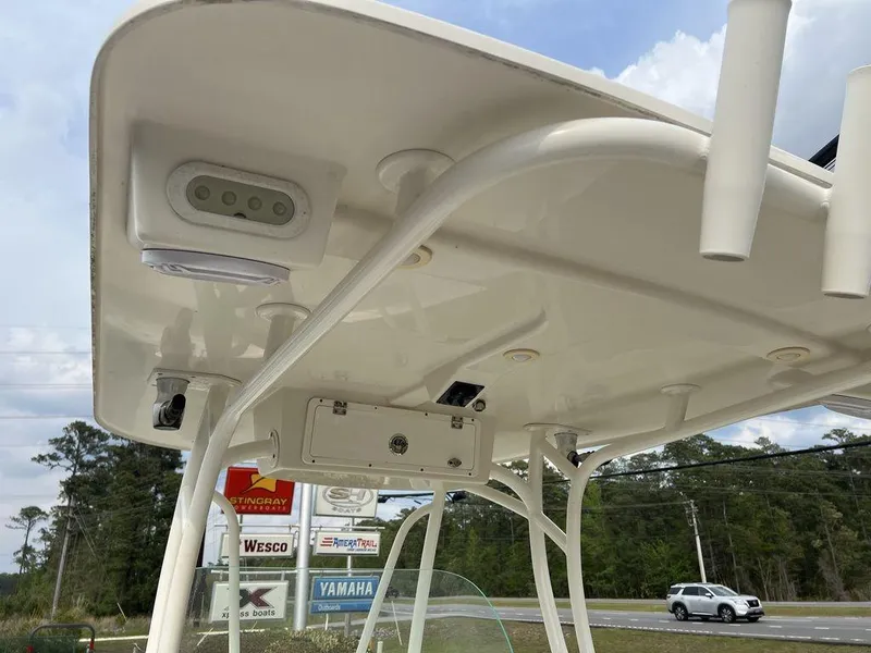 Slide: The Image of 2017 Sailfish 270 CC boat's T-top with mounted equipment and rod holders. - 23