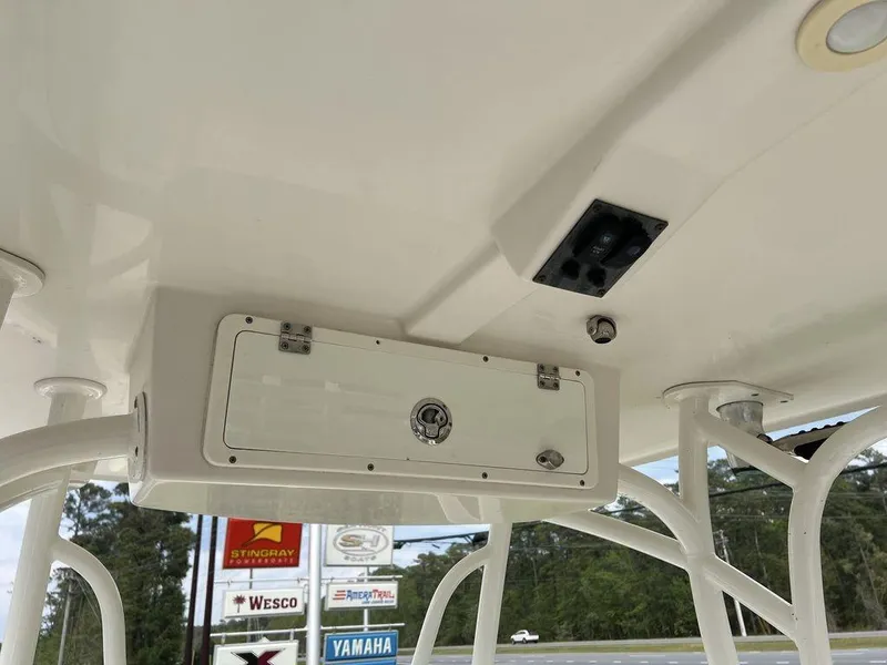 Slide: The Image of 2017 Sailfish 270 CC boat interior with storage compartment and overhead console. - 24