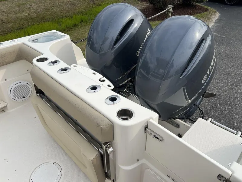 Slide: The Image of 2017 Sailfish 270 CC boat with dual Yamaha outboard engines, featuring rod holders and seating. - 25