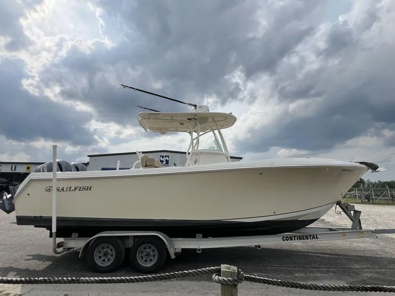 Slide: The Image of 2017 Sailfish 270 CC boat on trailer under cloudy sky. - 4