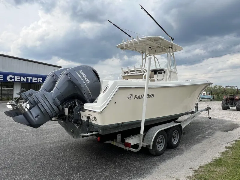 Slide: The Image of 2017 Sailfish 270 CC boat on trailer with Yamaha outboard, parked outdoors under cloudy sky. - 6