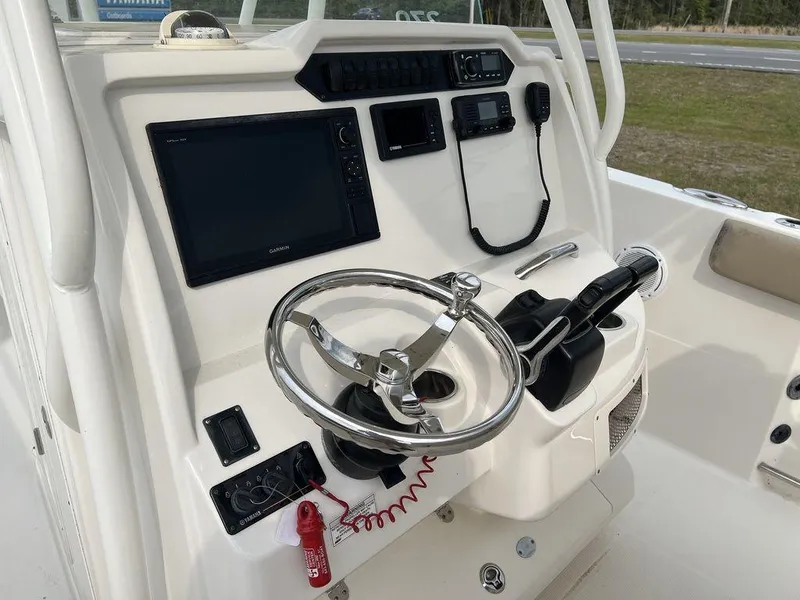 Slide: The Image of 2017 Sailfish 270 CC boat console with steering wheel and navigation equipment. - 9
