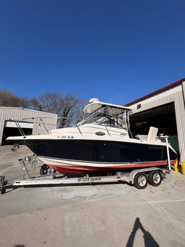 Slide: The Image of 2008 Century 2400 Walkaround boat on trailer, parked outside a storage facility. - 0