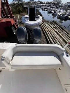 Slide: The Image of 2008 Century 2400 Walkaround boat with seating, docked near a marina. - 10