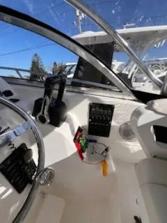 Slide: The Image of 2008 Century 2400 Walkaround boat cockpit with steering wheel and control panel. - 13