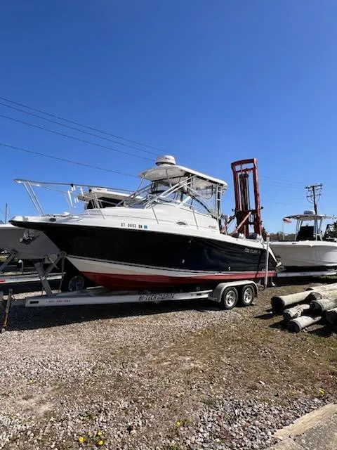 Slide: The Image of 2008 Century 2400 Walkaround boat on trailer under clear blue sky. - 2