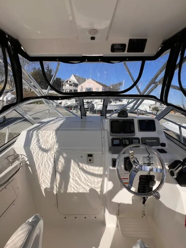 Slide: The Image of 2008 Century 2400 Walkaround boat interior with steering wheel and control panel. - 4