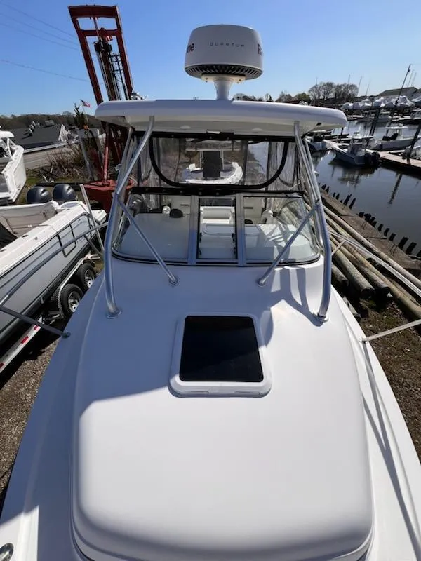 Slide: The Image of 2008 Century 2400 Walkaround boat docked, featuring radar and spacious deck. - 6